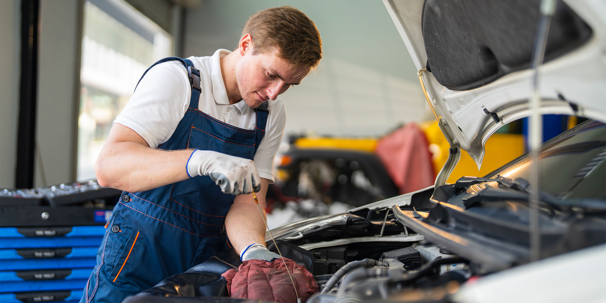 Mechanic servicing a car in a garage