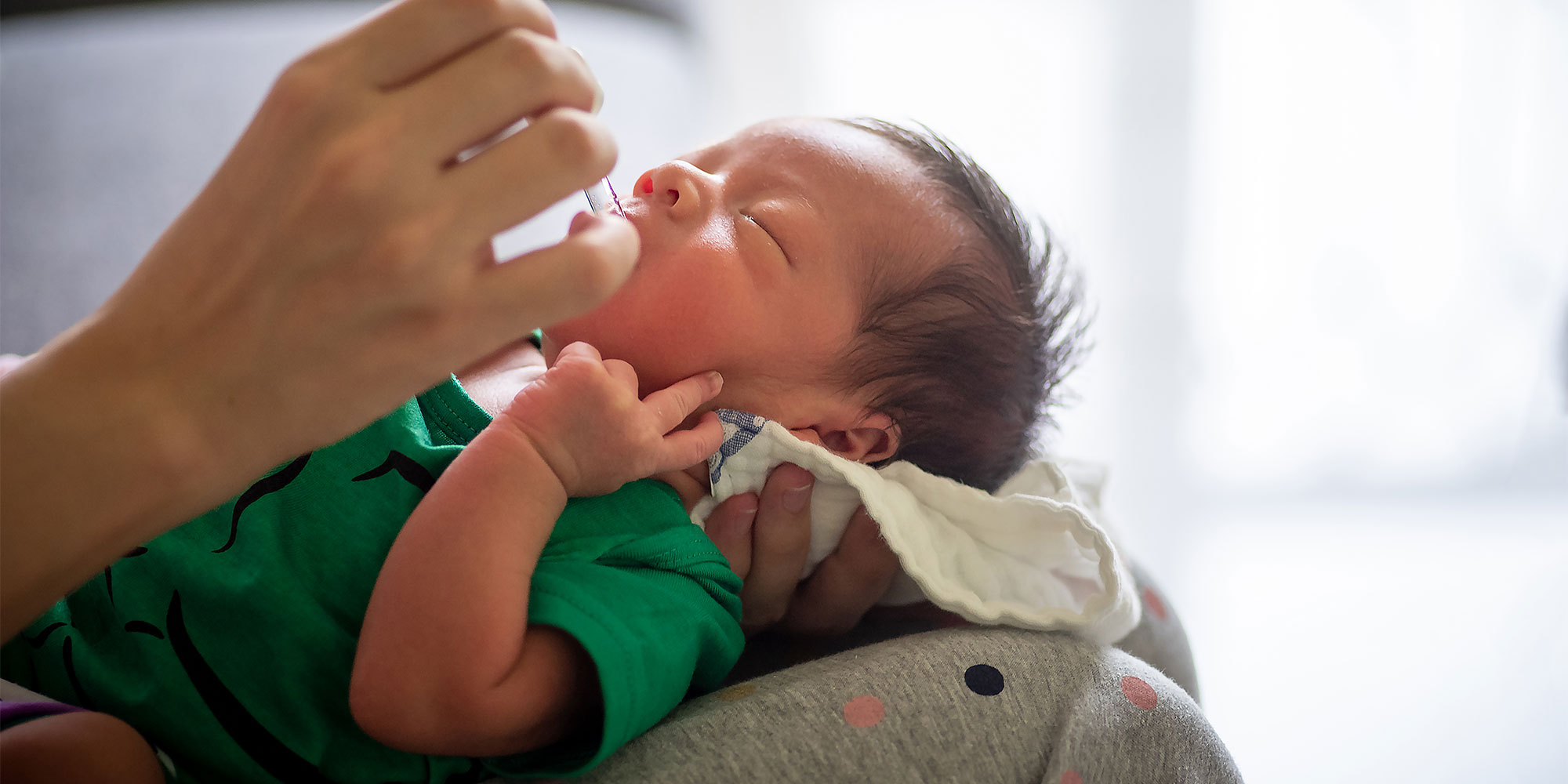 Baby being given vitamin d
