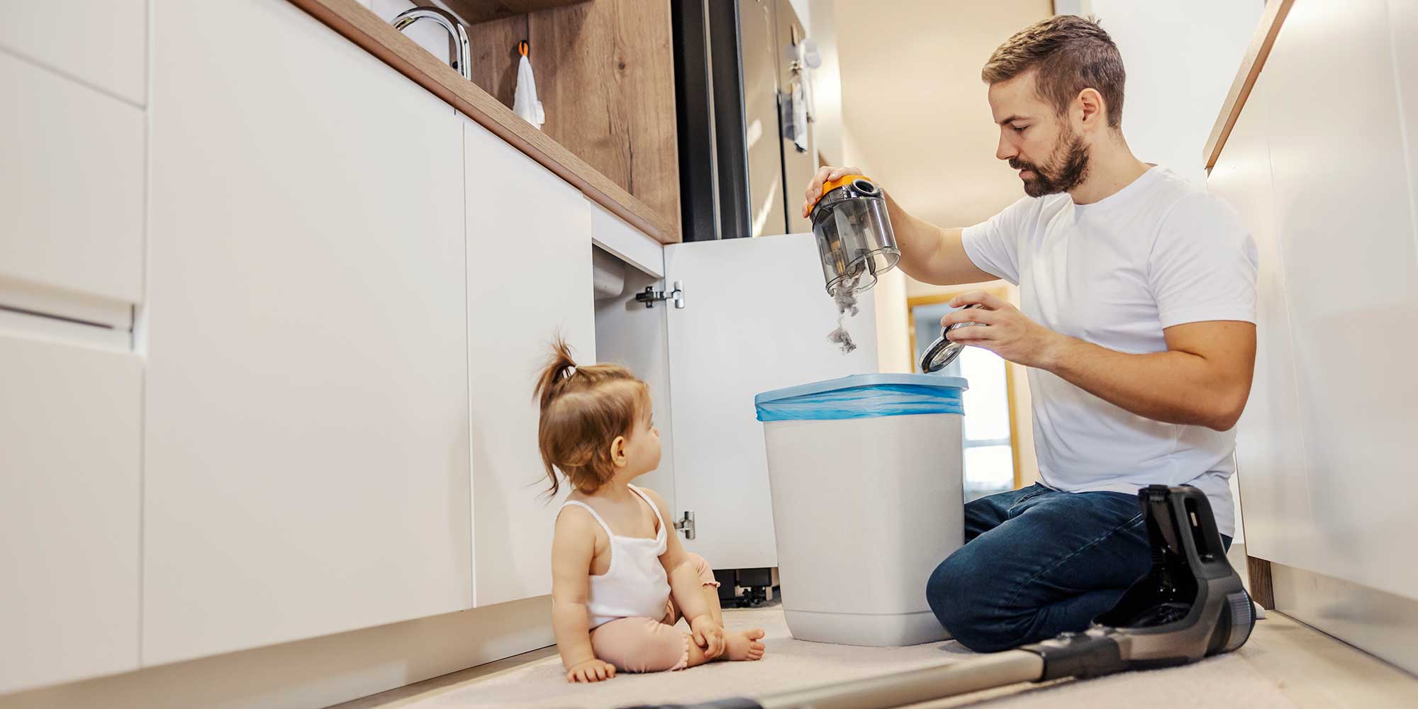 Person emptying a cordless vacuum cleaner bin