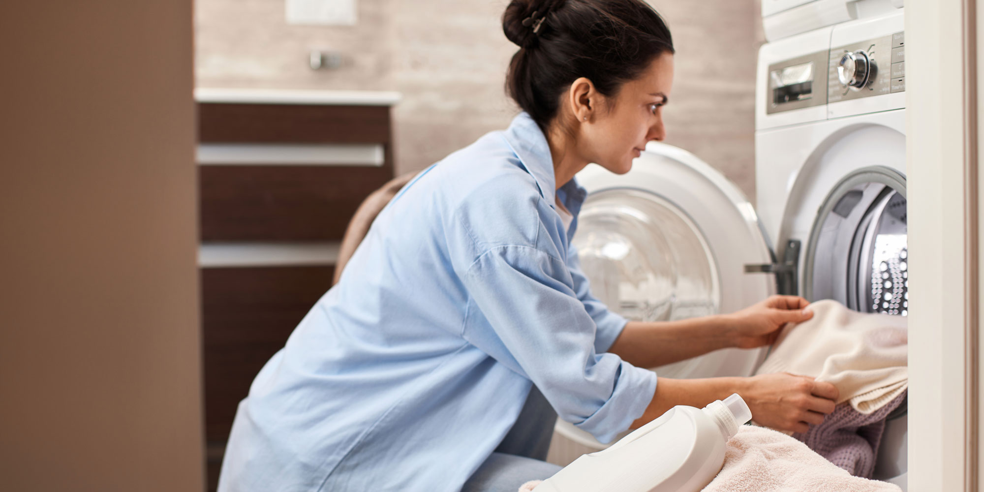 Woman unloads a washer-dryer