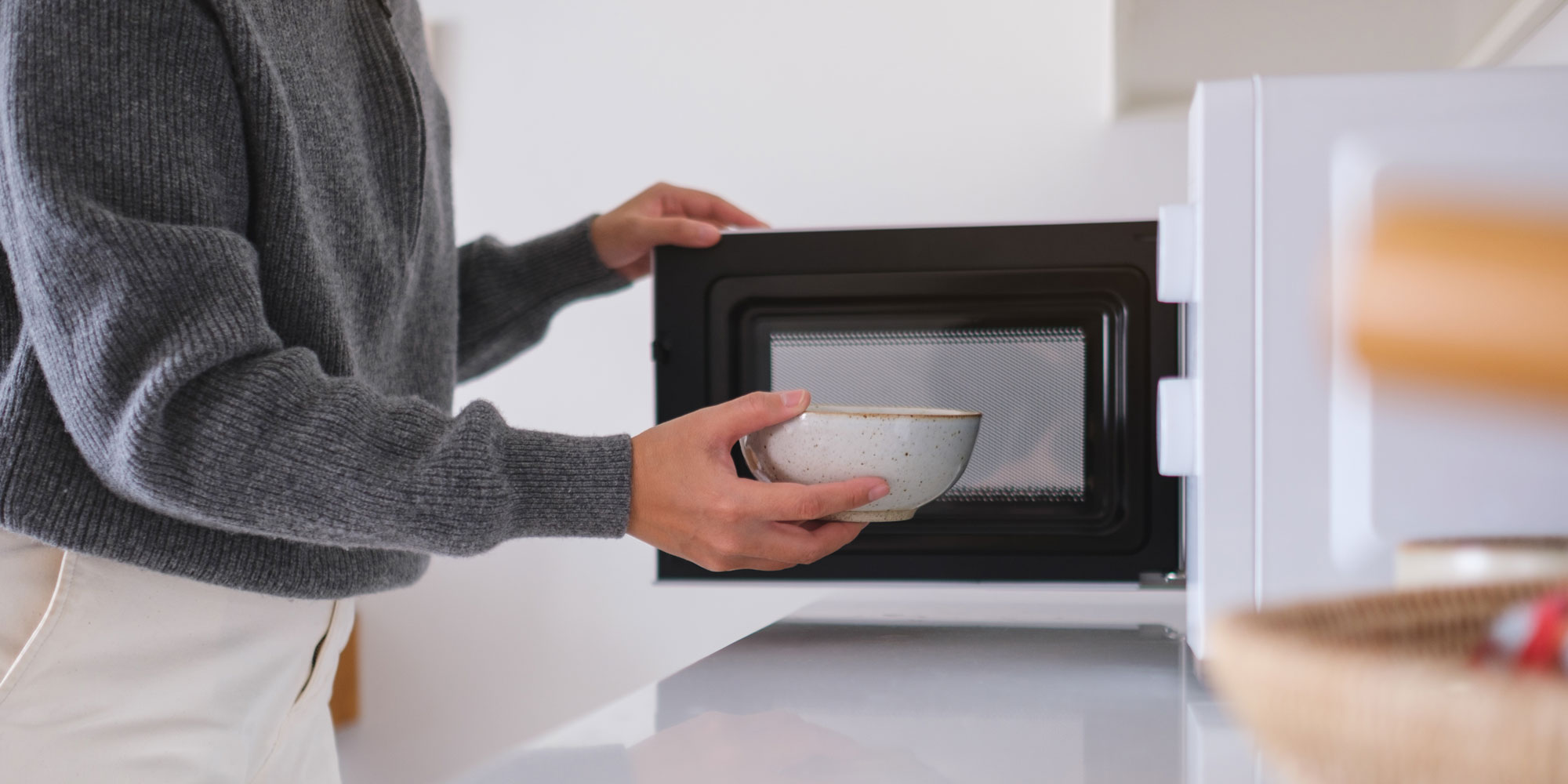 Woman warming up food in a microwave