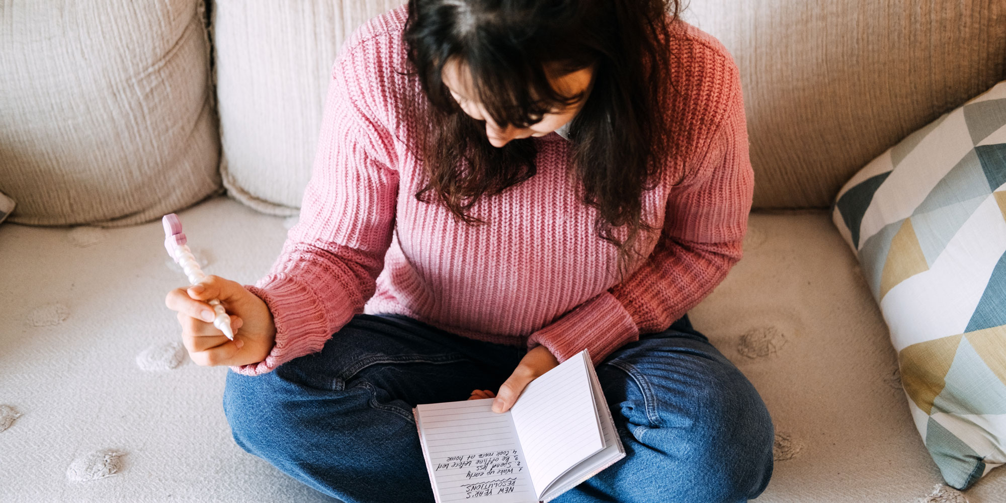 A woman with a diary setting her new year resolutions