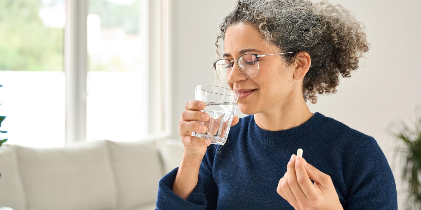 A women taking a supplement