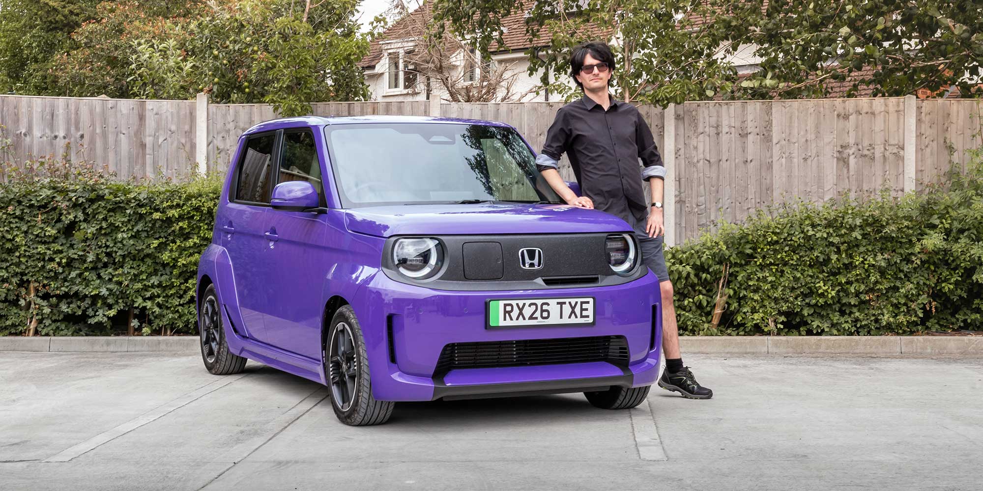 Dino Buratti standing next to a purple Honda Super-N car.