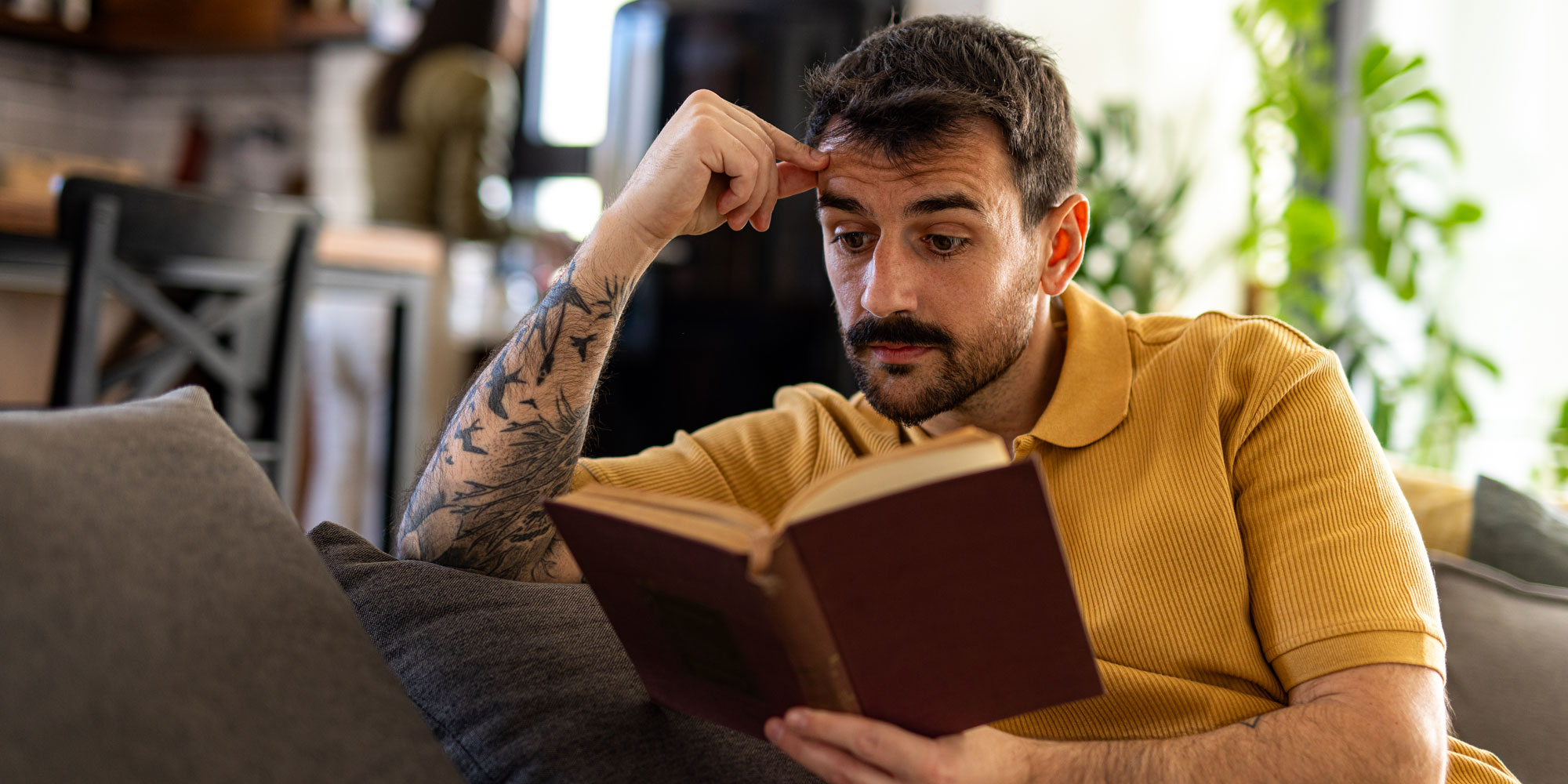 A man peering quite closely at a book