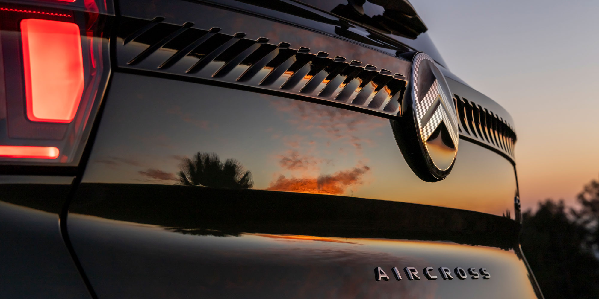 The rear of the Citroen C3 Aircross with a sunset in the background