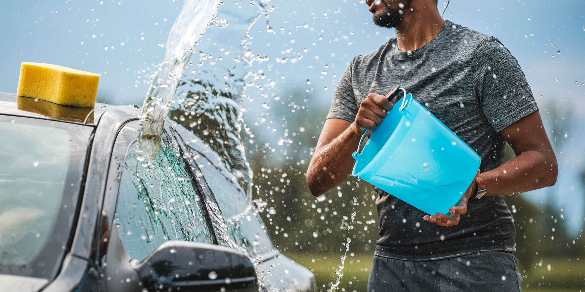 Splashing the car with a bucket full of water