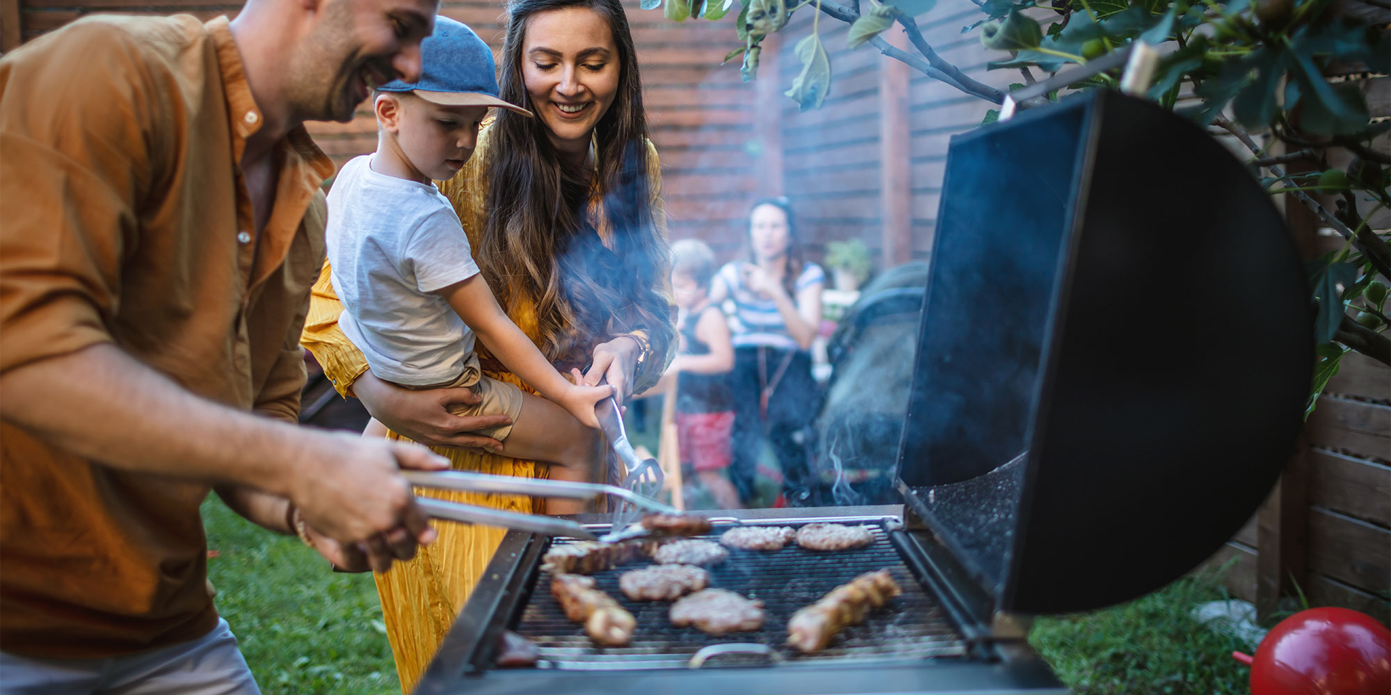 a man grilling meat outdoors