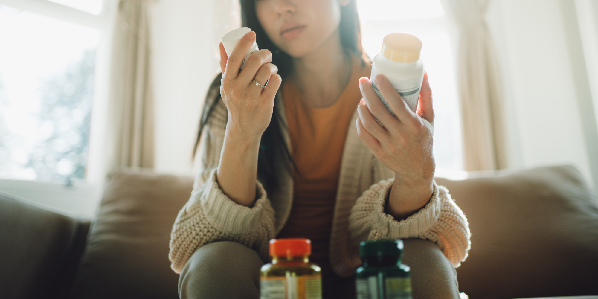 Woman examining lots of different types of supplements