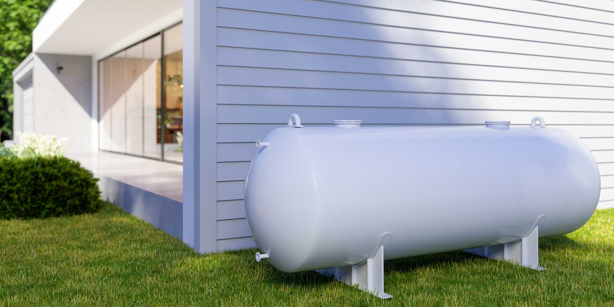 Heating oil tank next to the wall of a modern white house