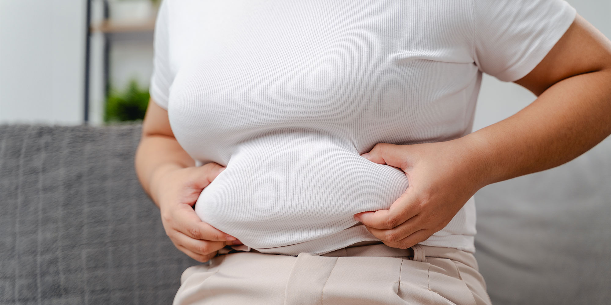 A woman pinching her belly