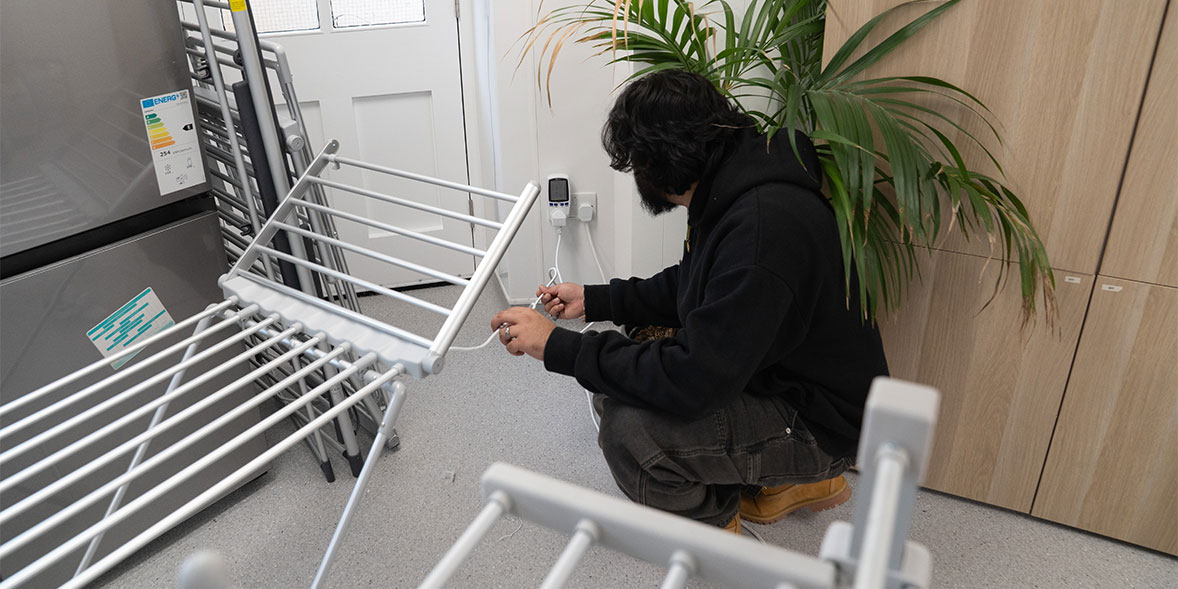 Out tester checking the heated airer is plugged into the energy reader