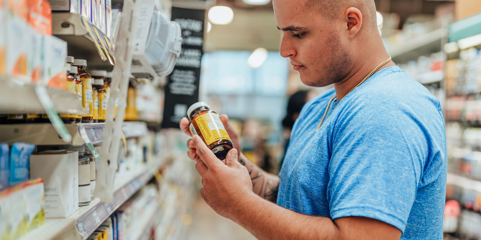 A man looking at supplements in a shop