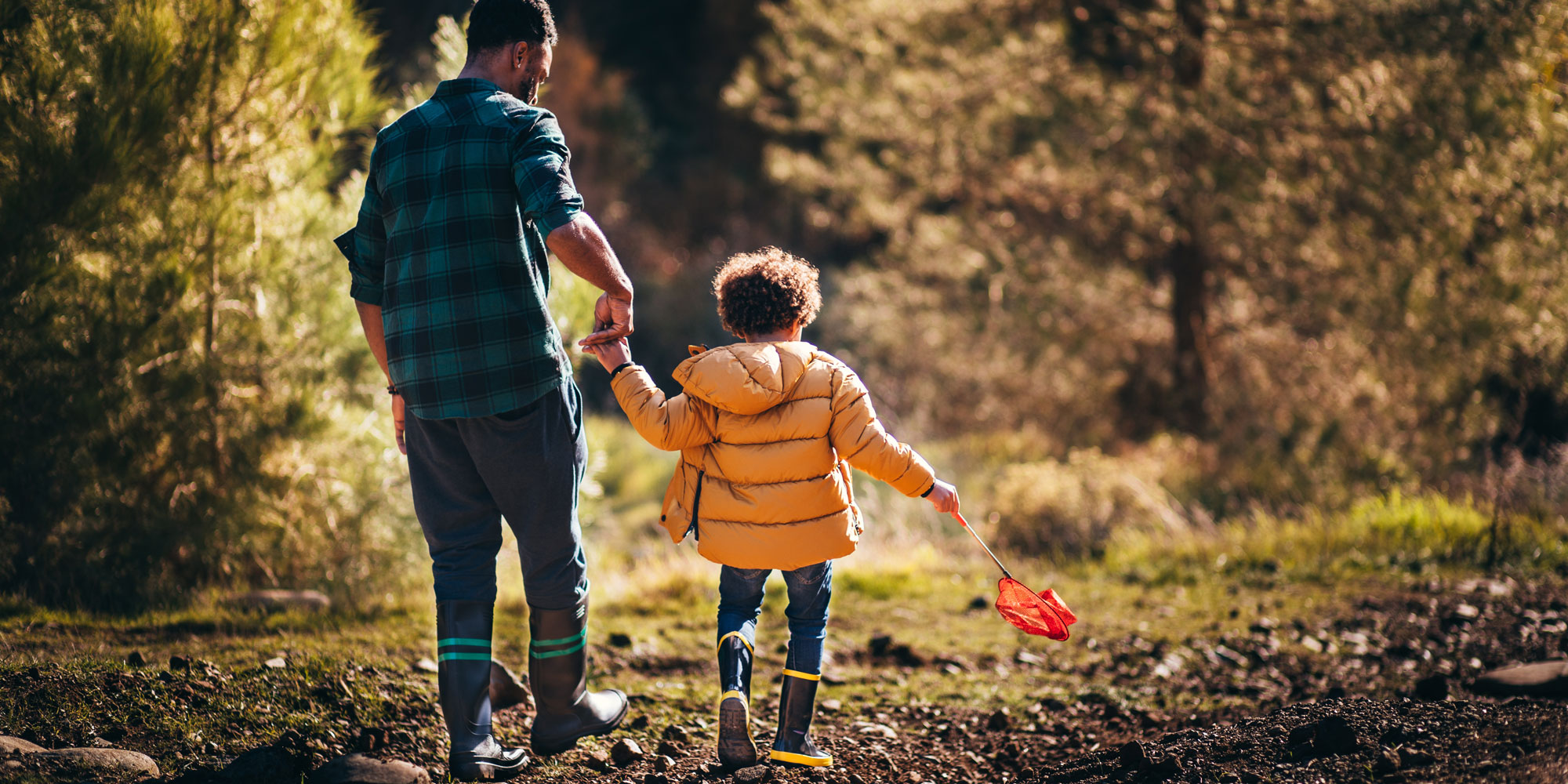 Dad and son walking in wellies