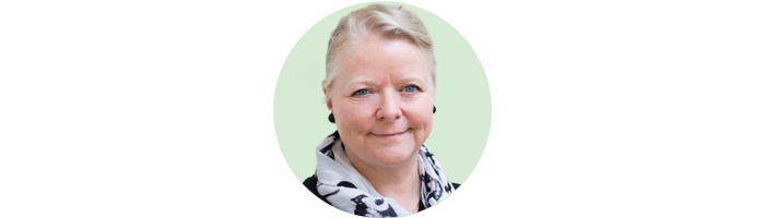 woman smiling at camera on mint green  background