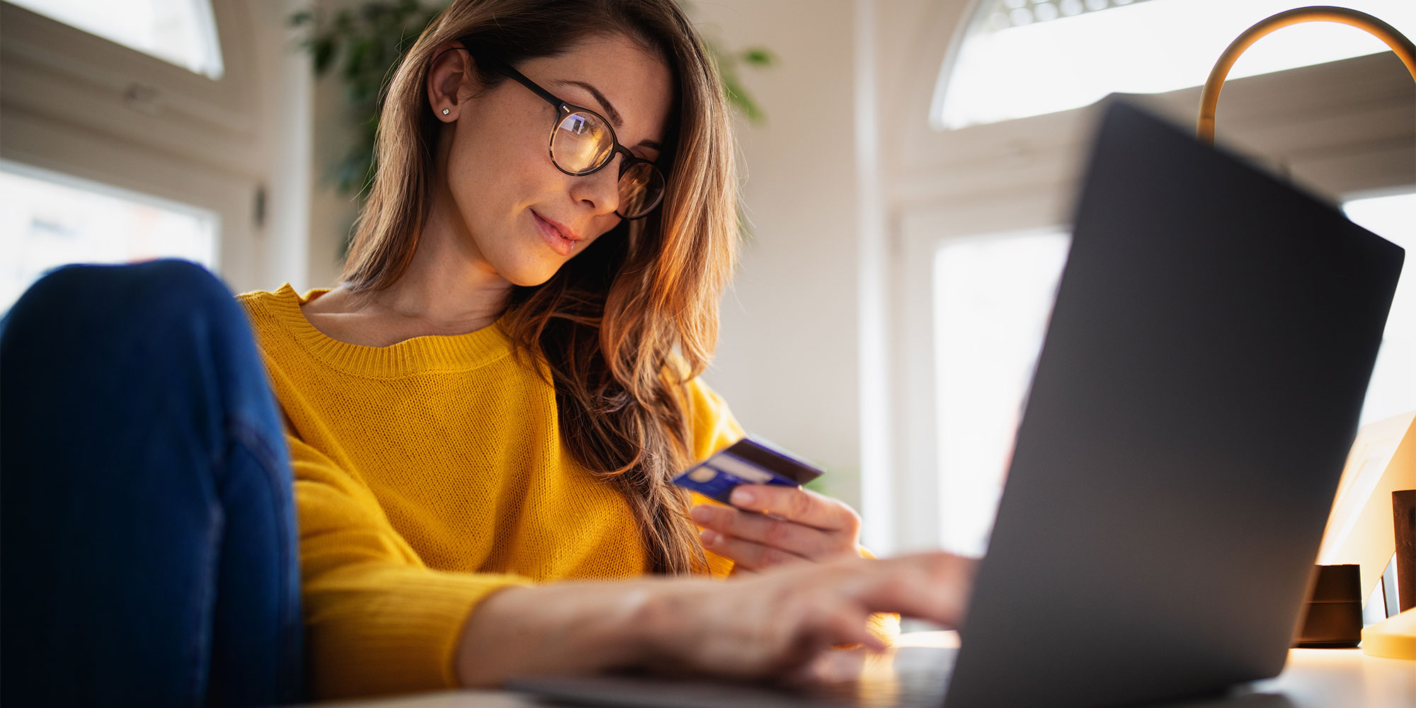 Woman buying air conditioner online using a laptop