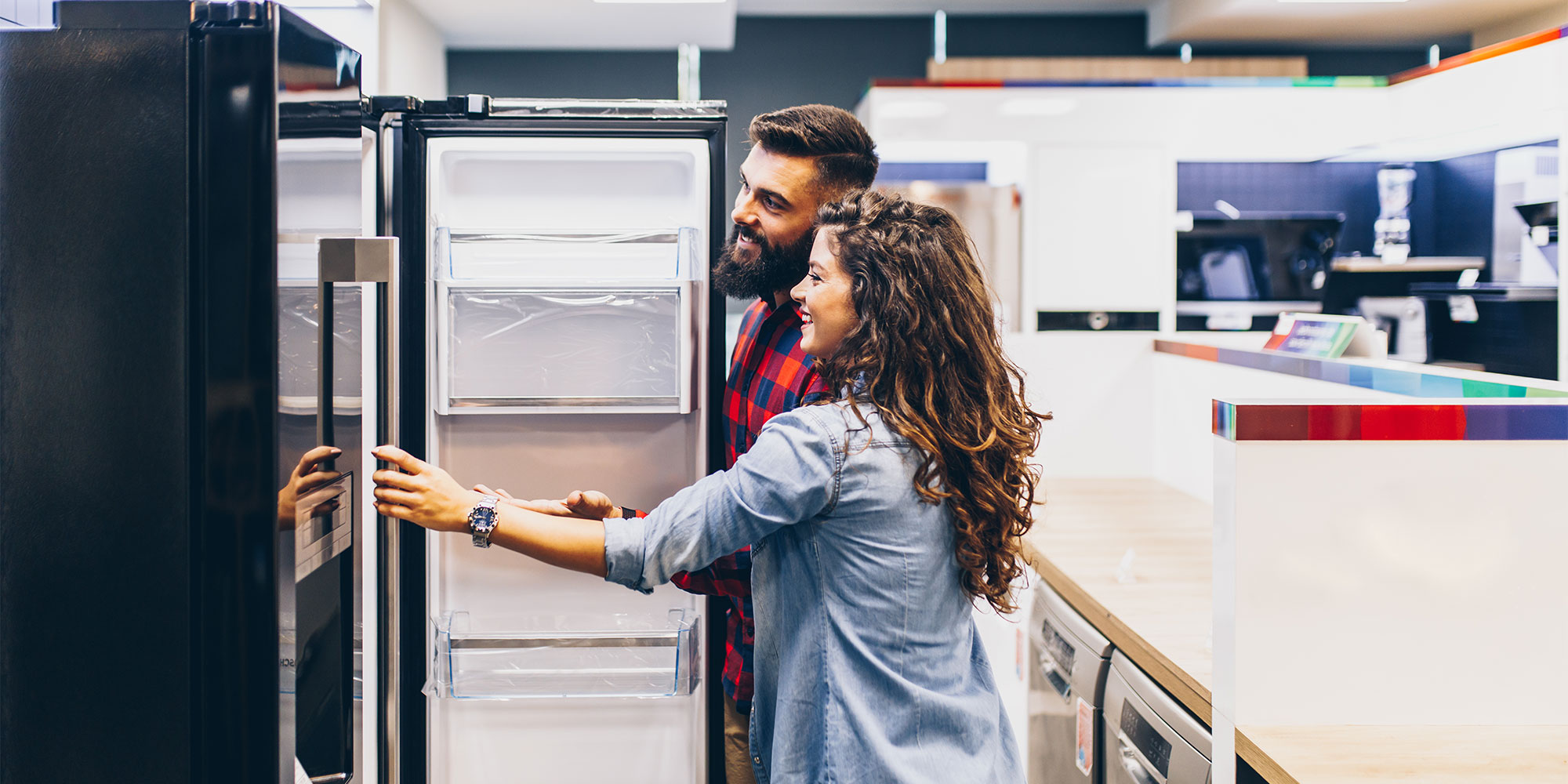 Couple shopping for a new fridge freezer