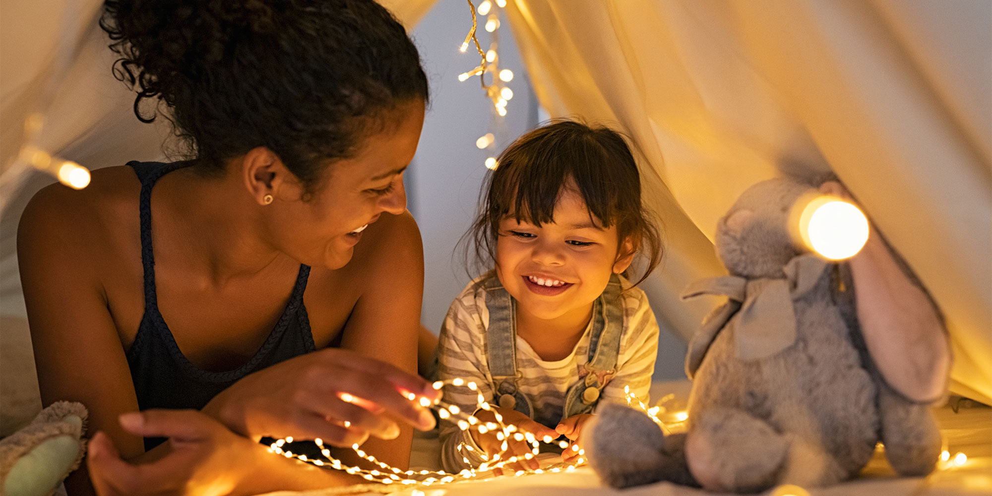 Woman and child surrounded by fairly lights