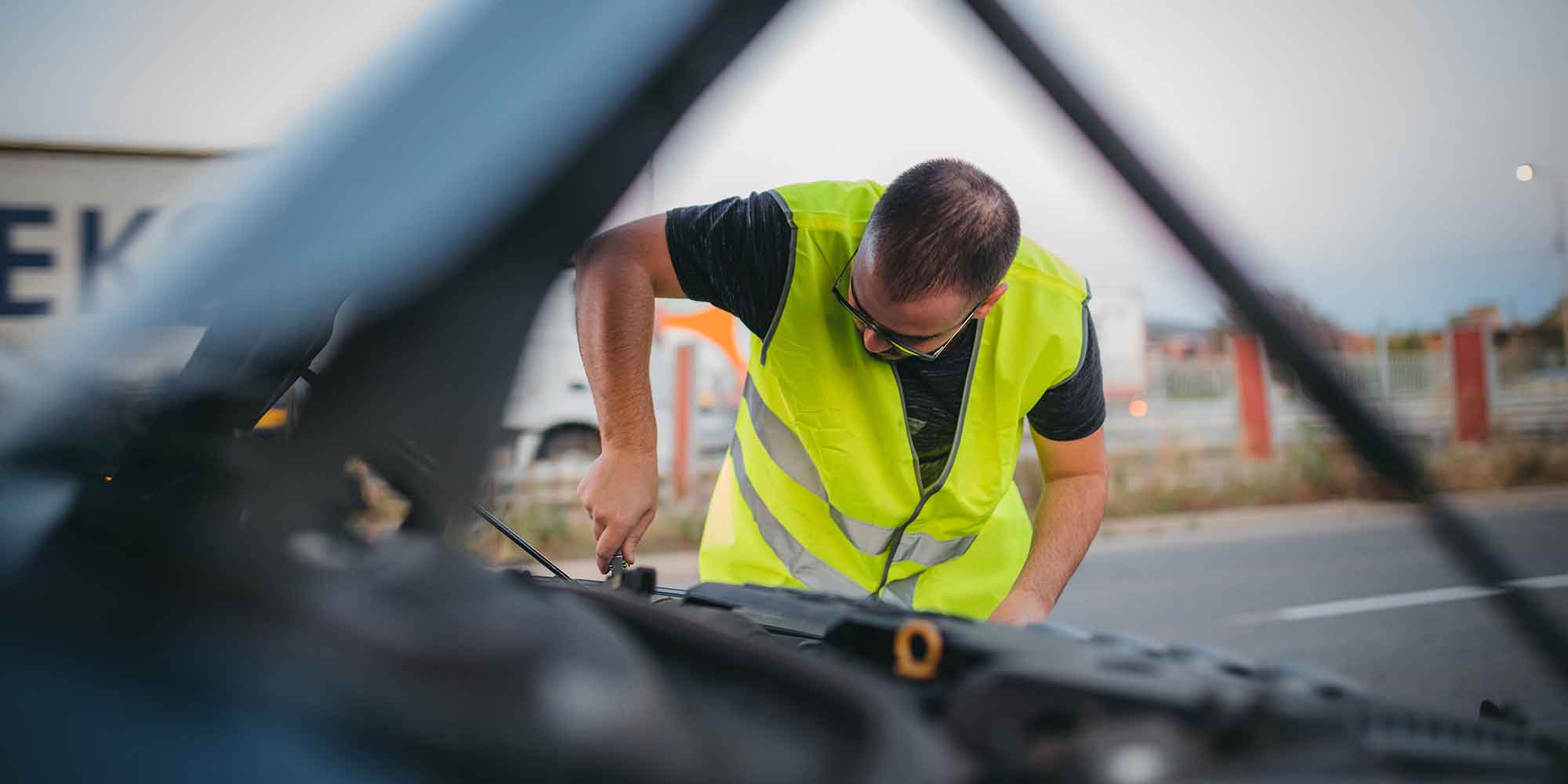 Mechanic attending to a car broken down on the roadside