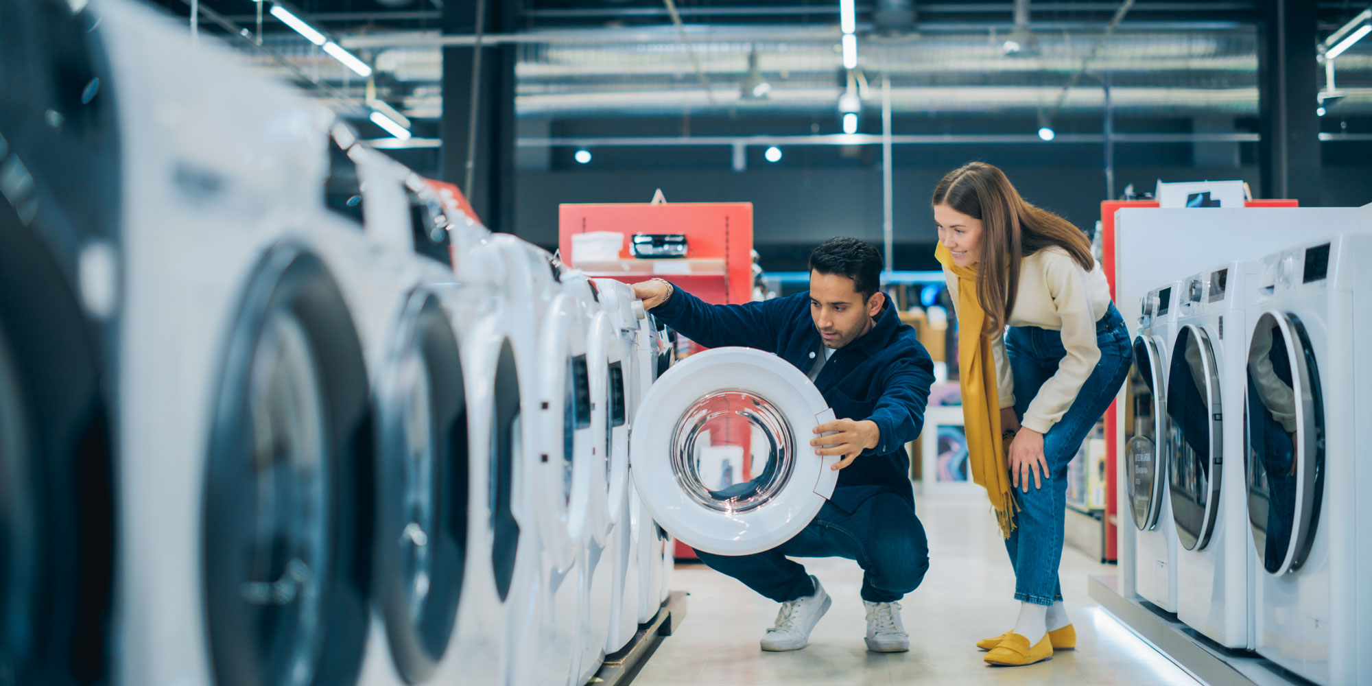 Couple shopping for washer-dryers
