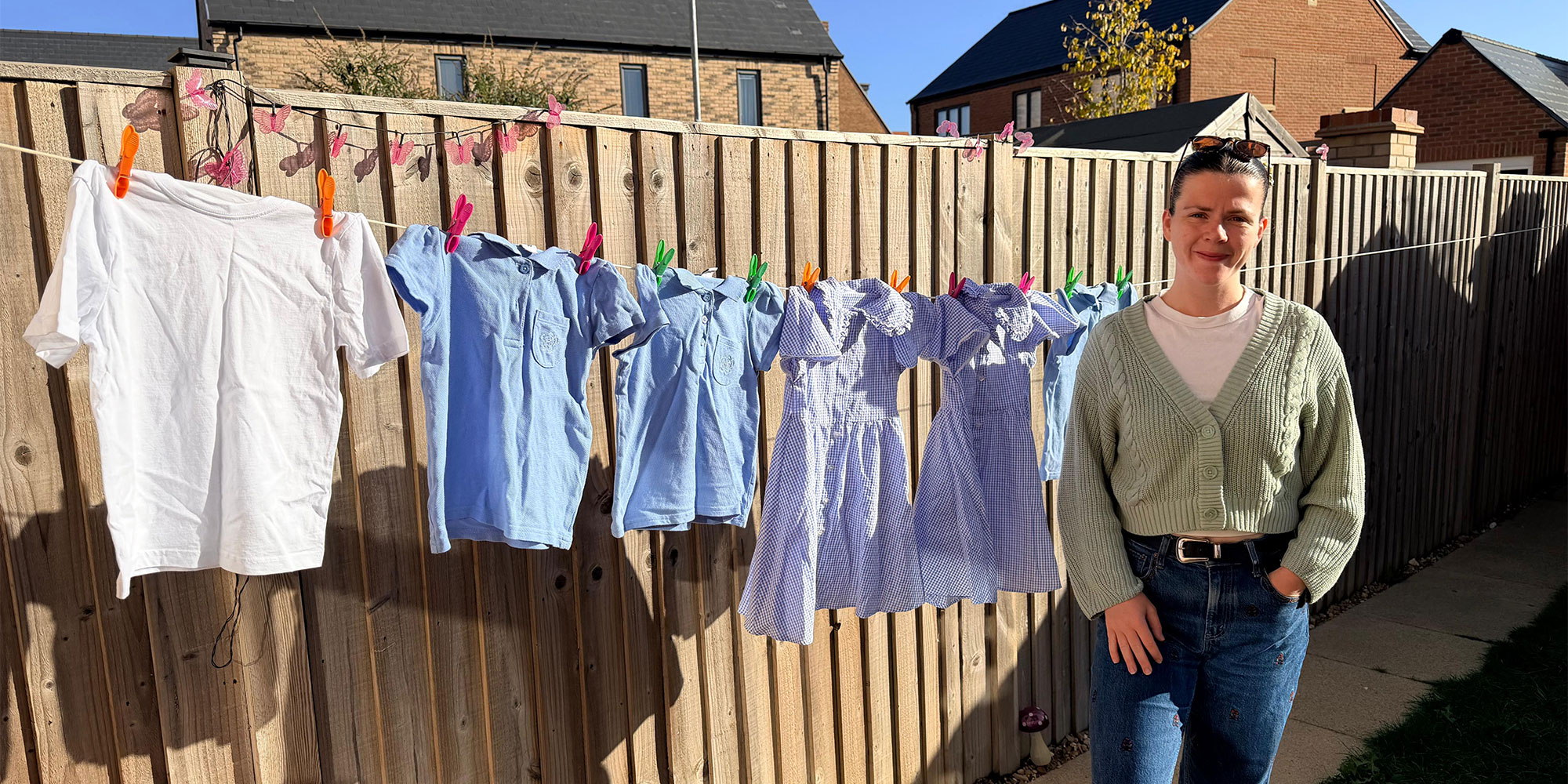Which? washing machines expert, Becki, standing in front of her daughter's uniform on the washing line