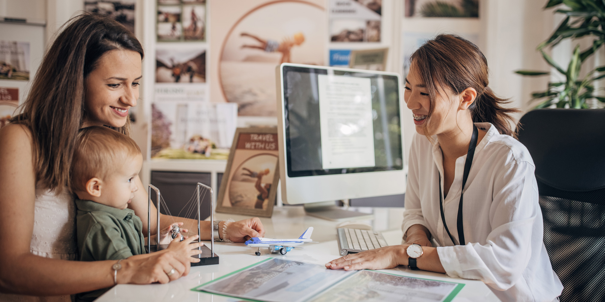 A holidaymaker making a booking at a high-street travel agent for their family