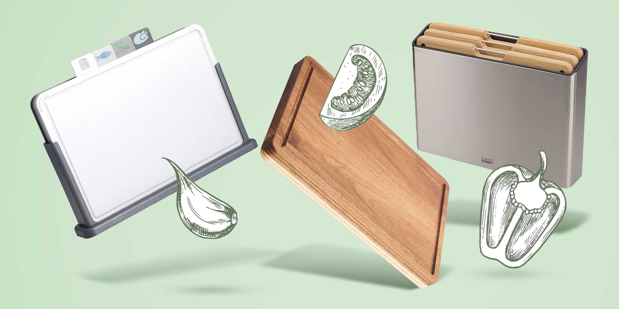 Three wooden and plastic chopping boards surrounded by fruit and veg