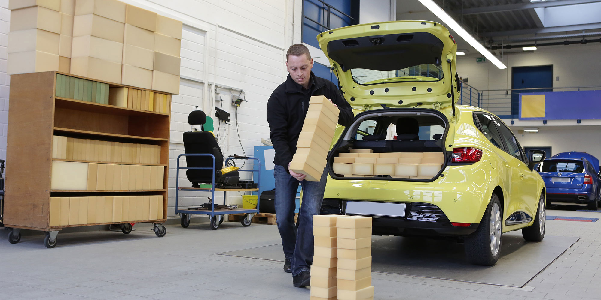 Foam blocks being loaded into a hatchback car