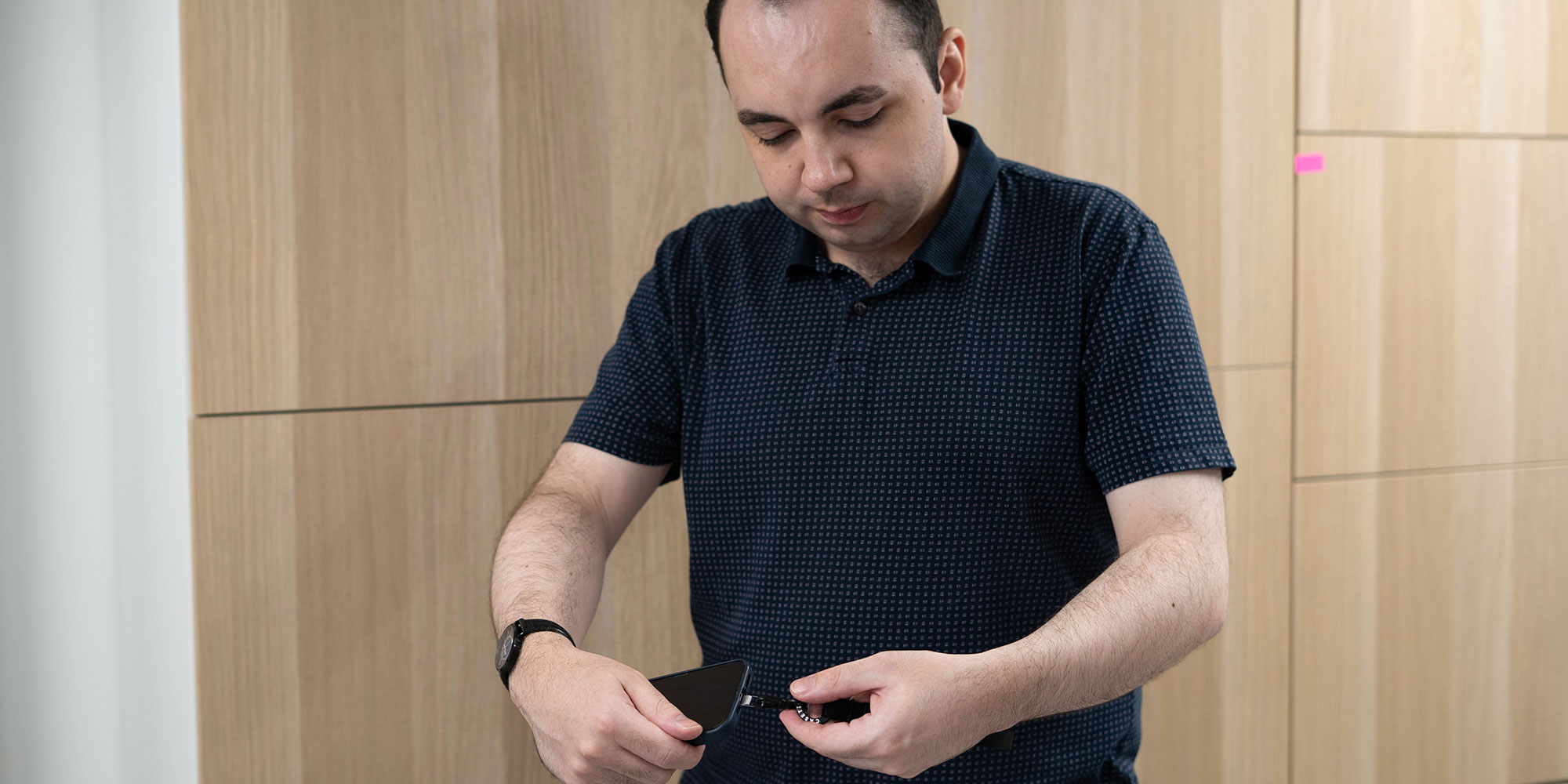 Callum Pears testing a mobile phone lanyard