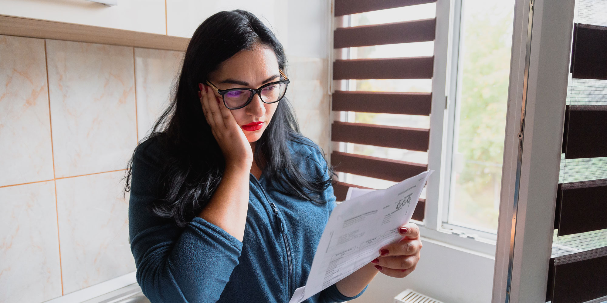 Woman reading a bill