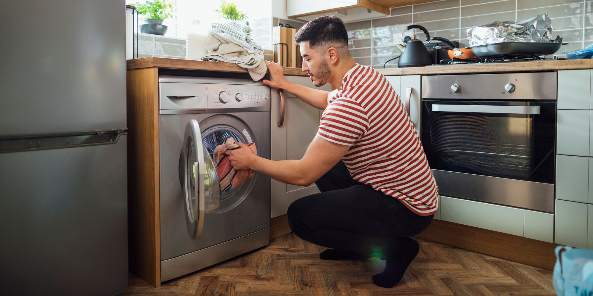 Man unloading washer-dryer