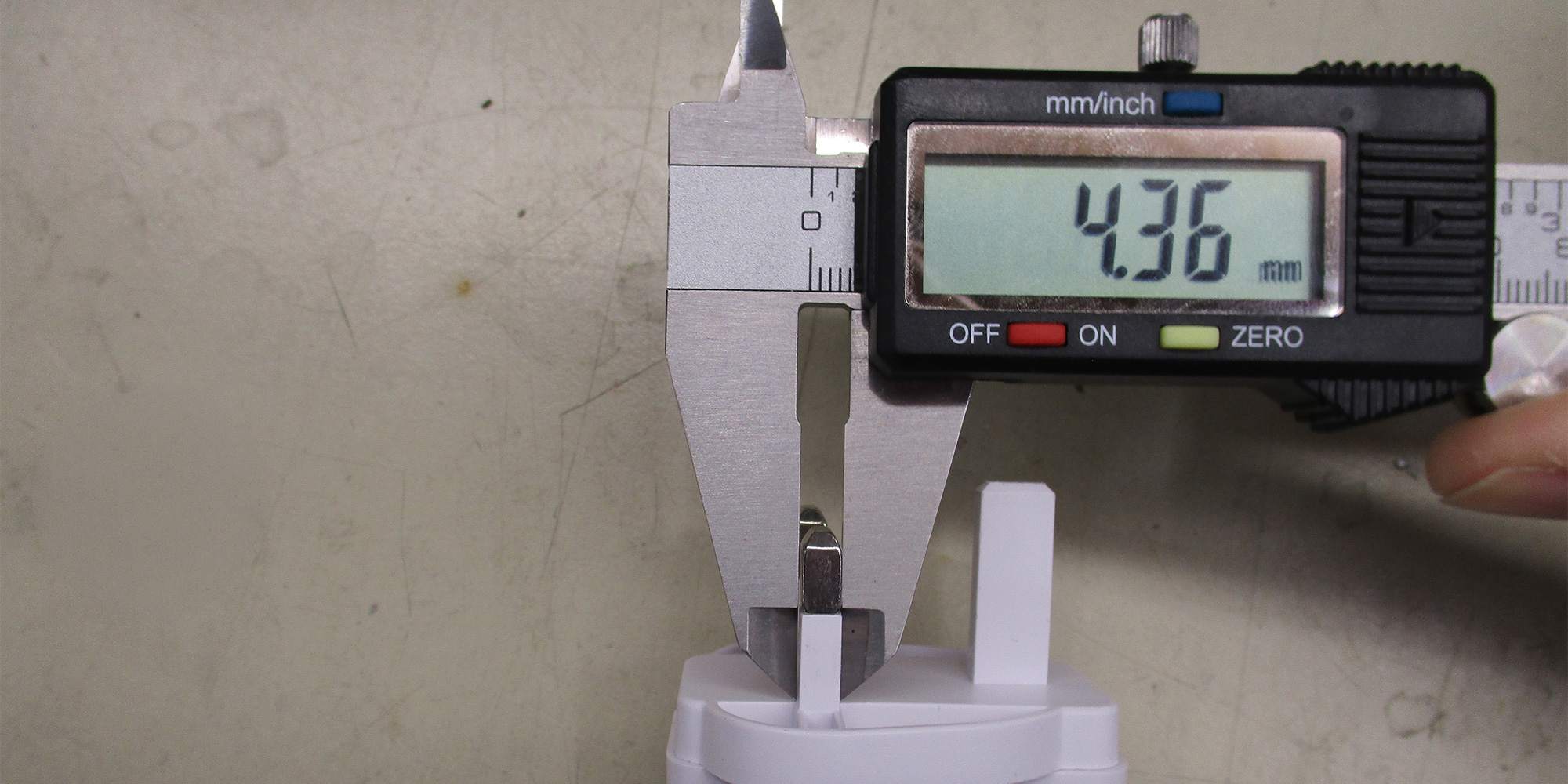 We measure the dimensions of each charger's pins to make sure they will fit into a socket safely without posing an electric shock hazard to people or causing damage to the socket. The pins on this charger are between 6% and 12% too thick.