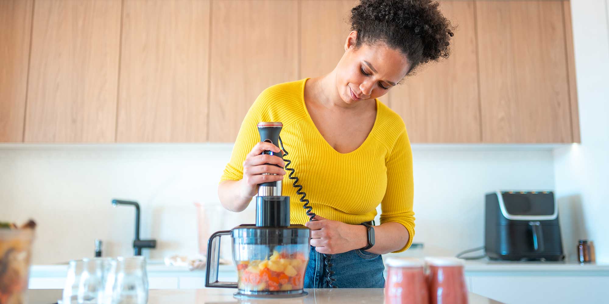 person using a blender in the kitchen