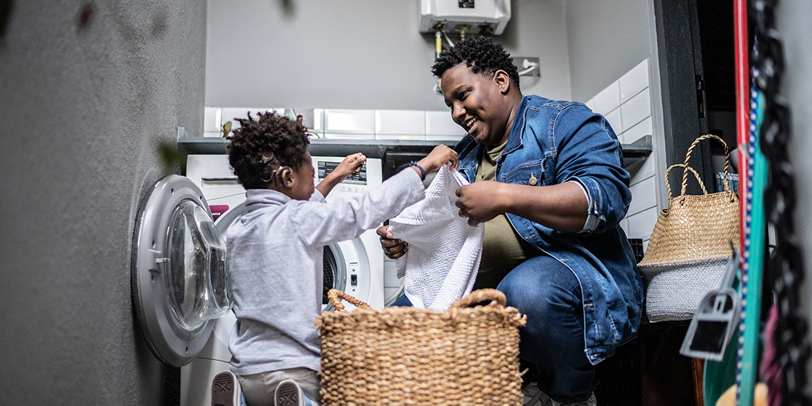 Parent and child doing laundry
