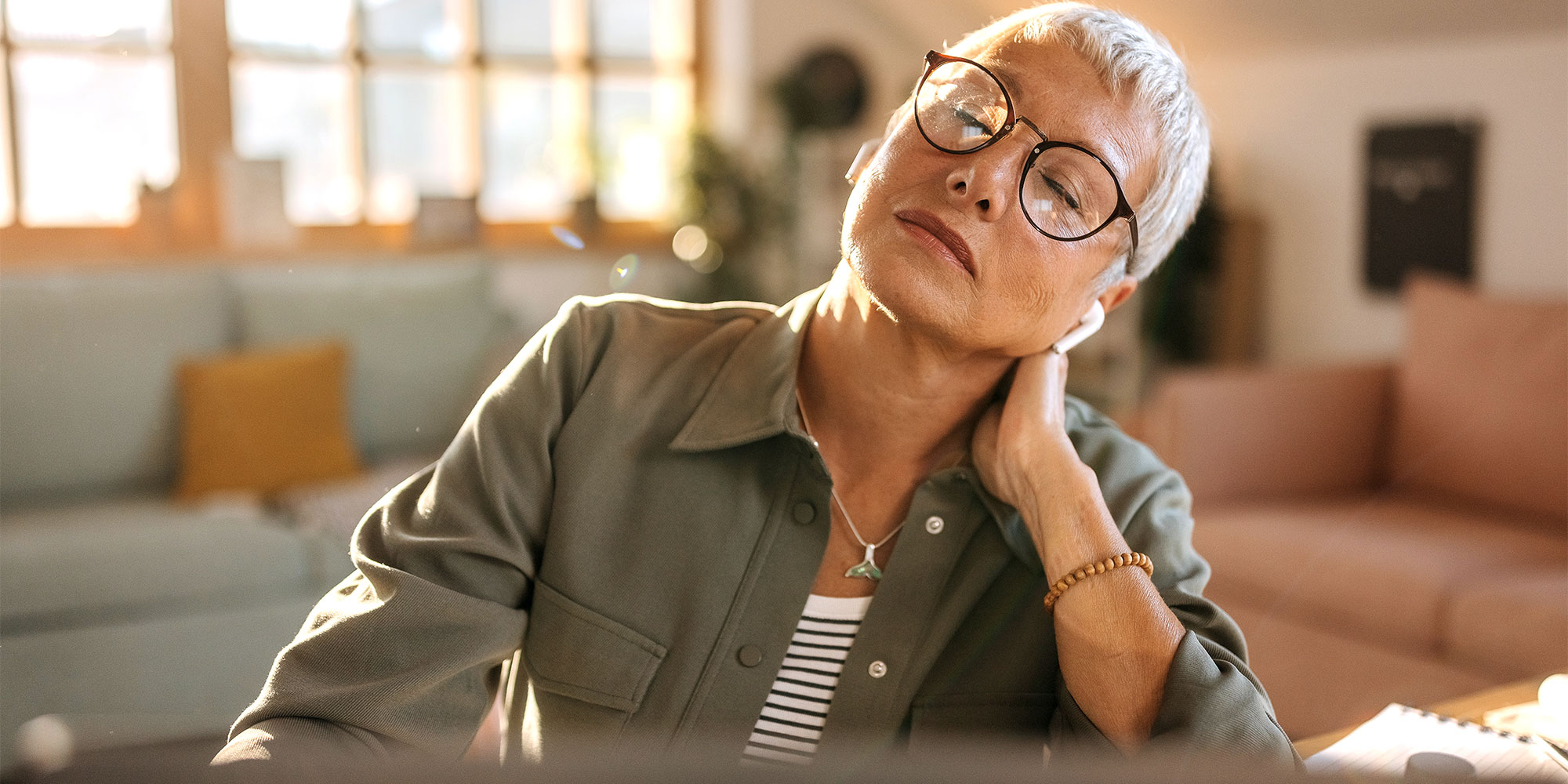 A stressed woman stretching her neck