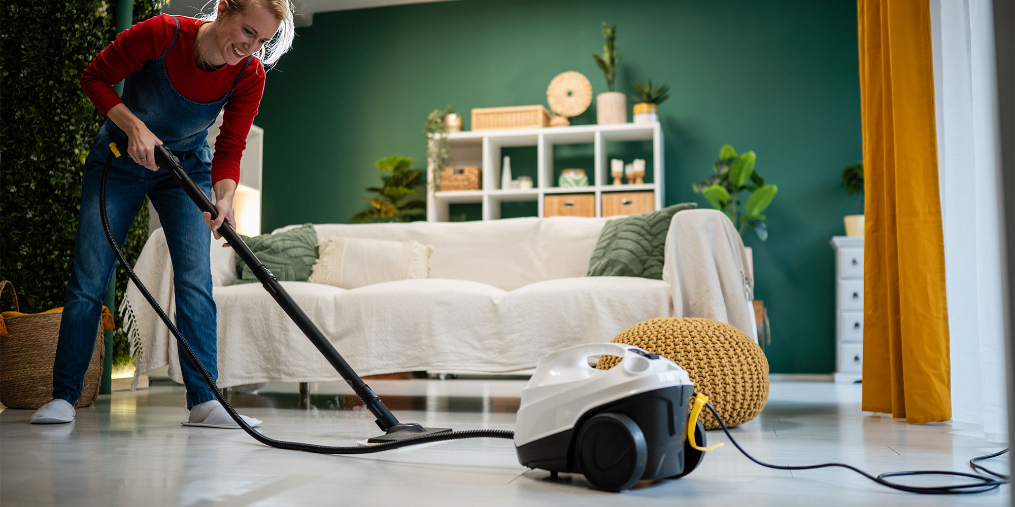 A cylinder steam cleaner being used on hard floors.