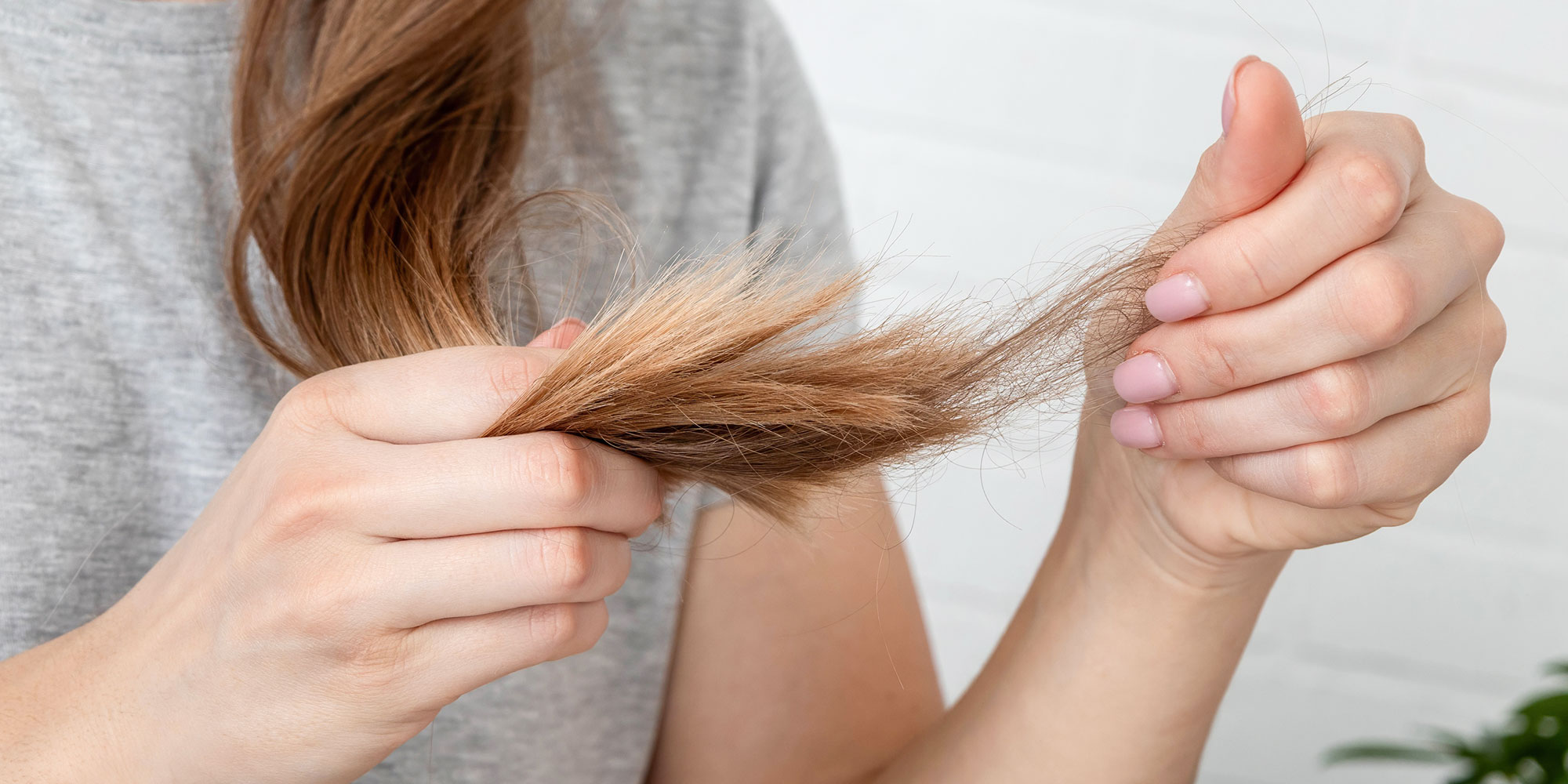 A woman examining her hair ends