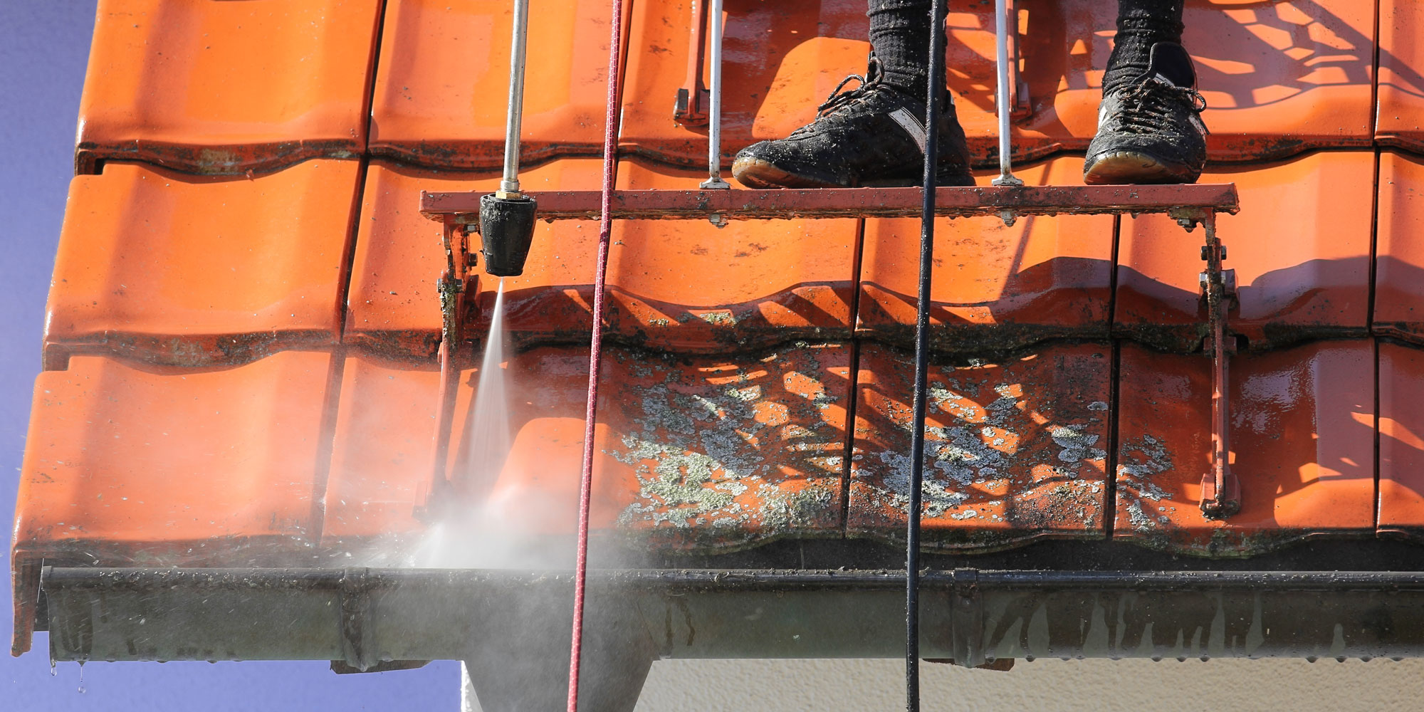 Cleaning gutter with pressure washer