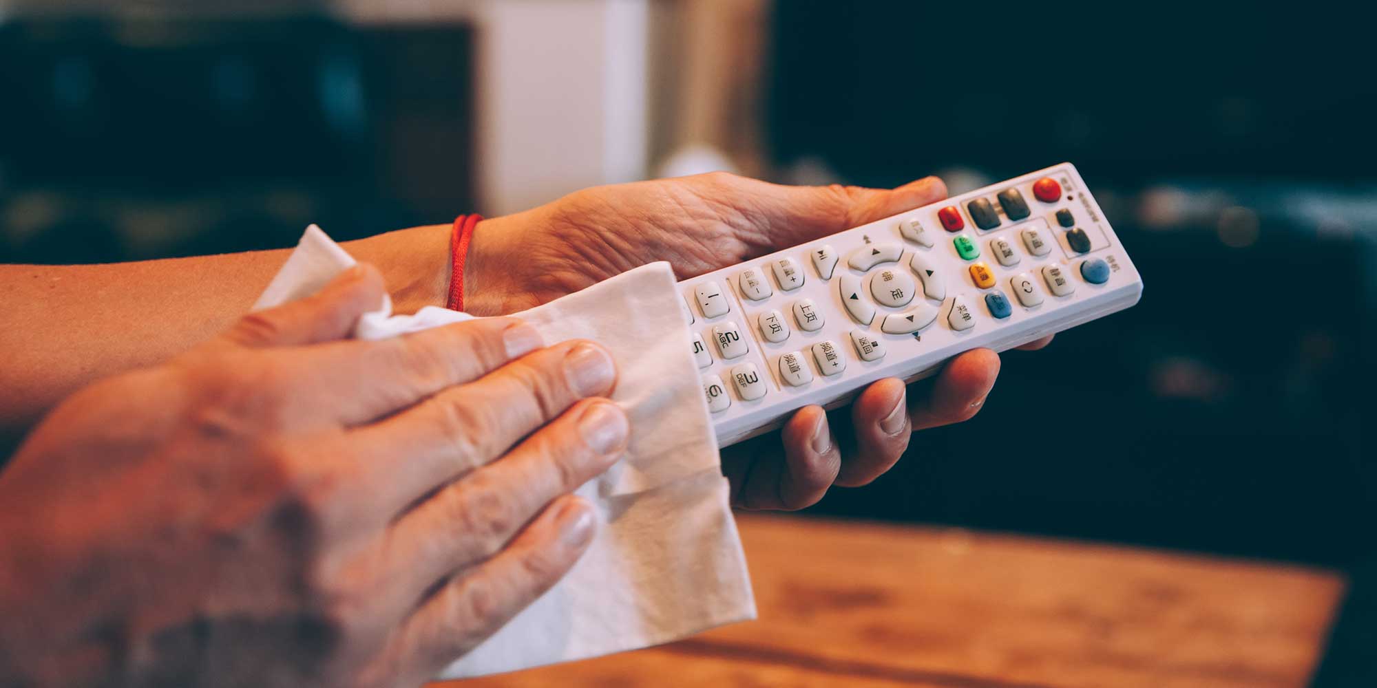 A TV remote control being wiped
