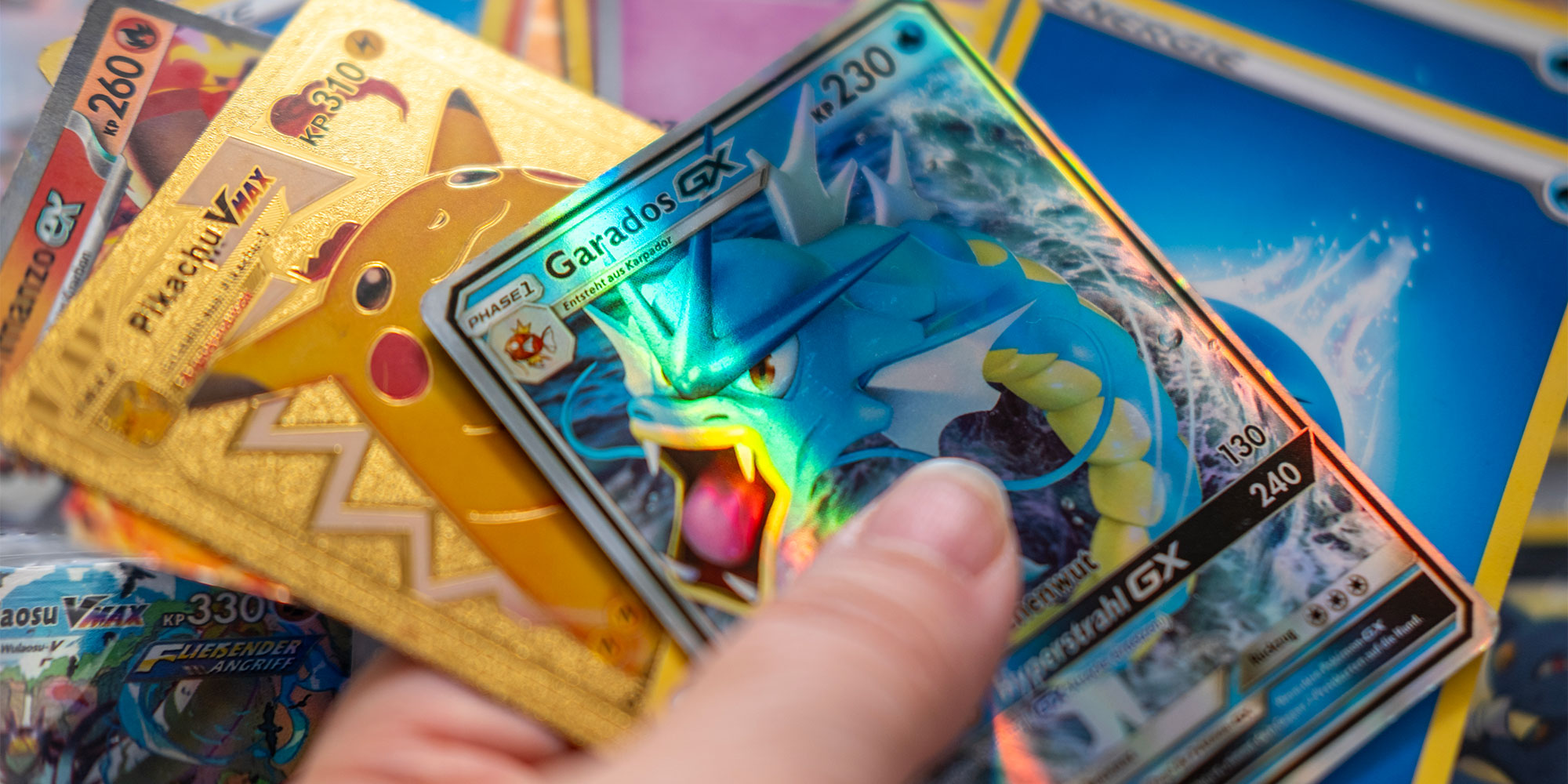 someone holding several pokemon cards