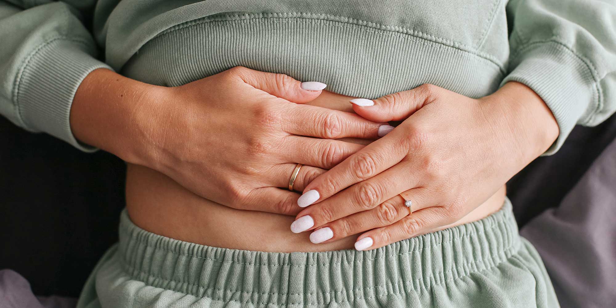 Hands over someone's stomach, to illustrate the gut-brain connection