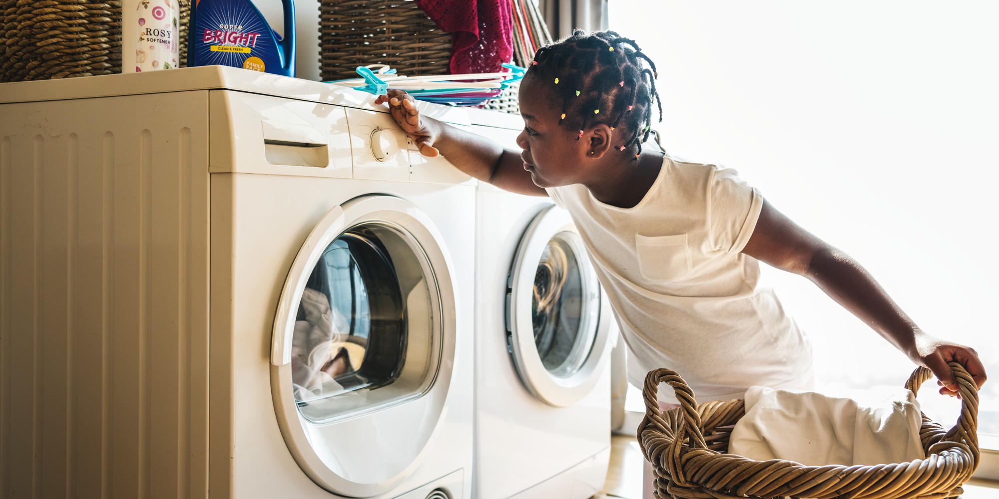 Little girl next to washing machine