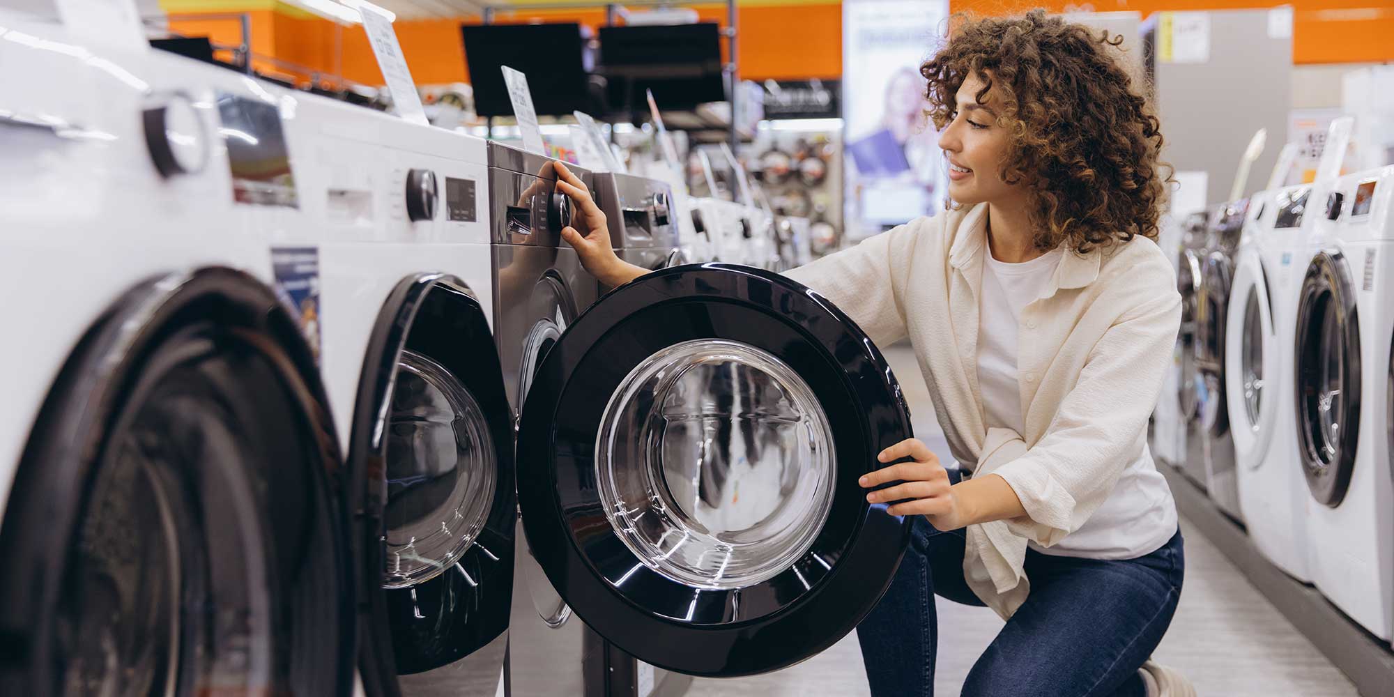 Woman browsing tumble dryers in store