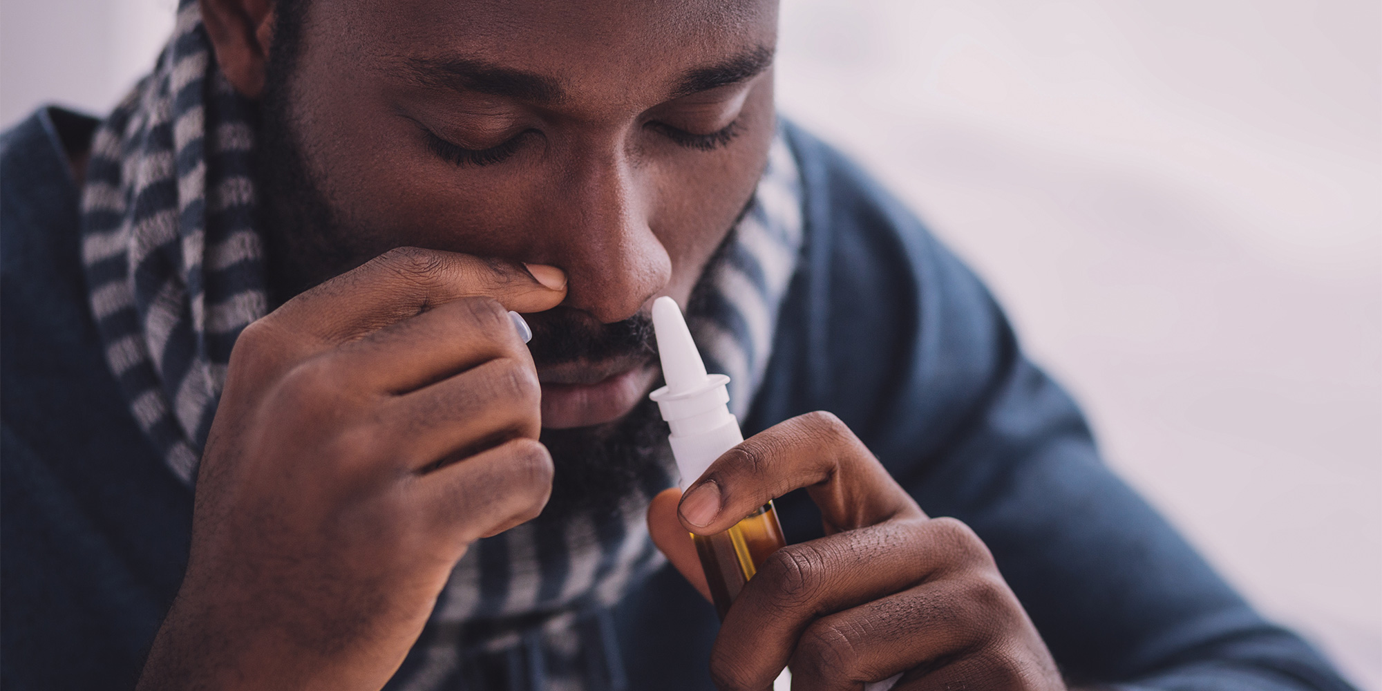 Man using nose spray