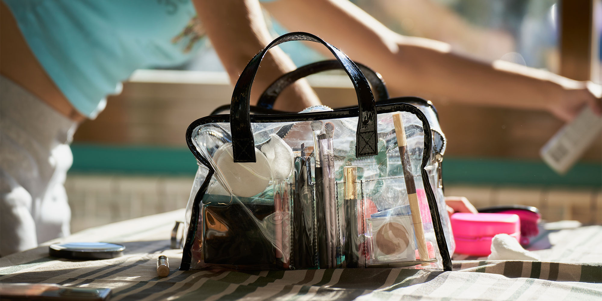 See through wash bag containing makeup brushes, pads and more