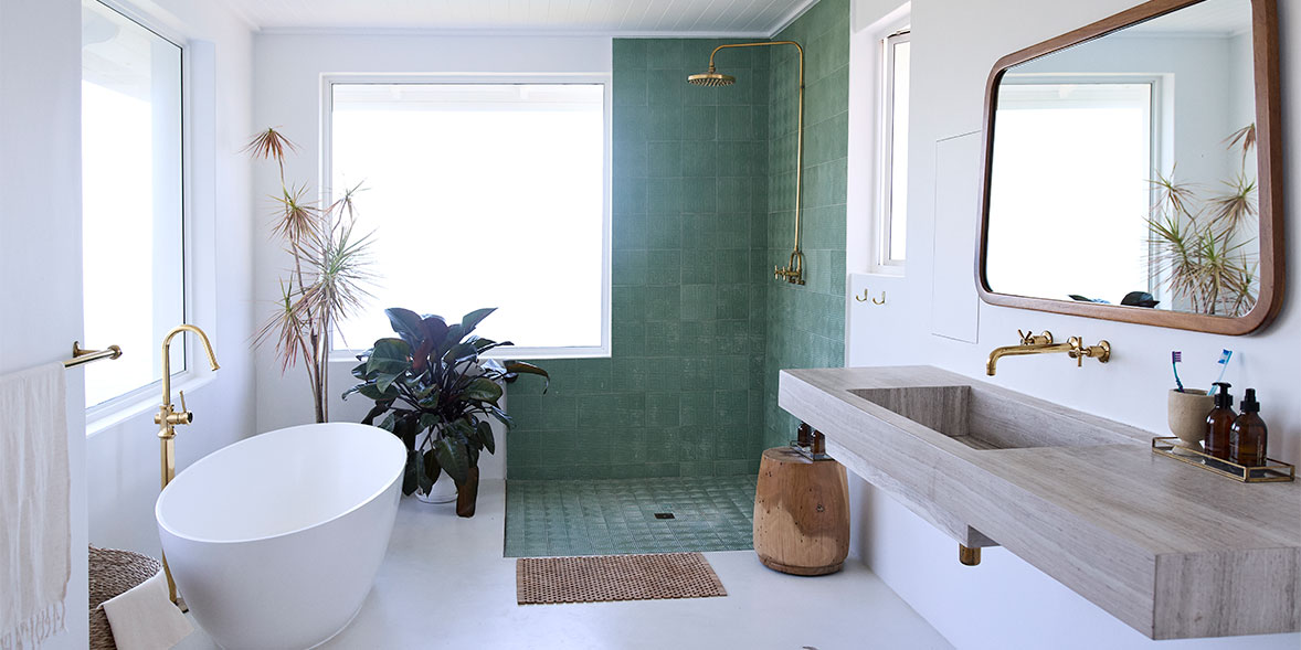 bathroom with freestanding bath, open shower, sink 