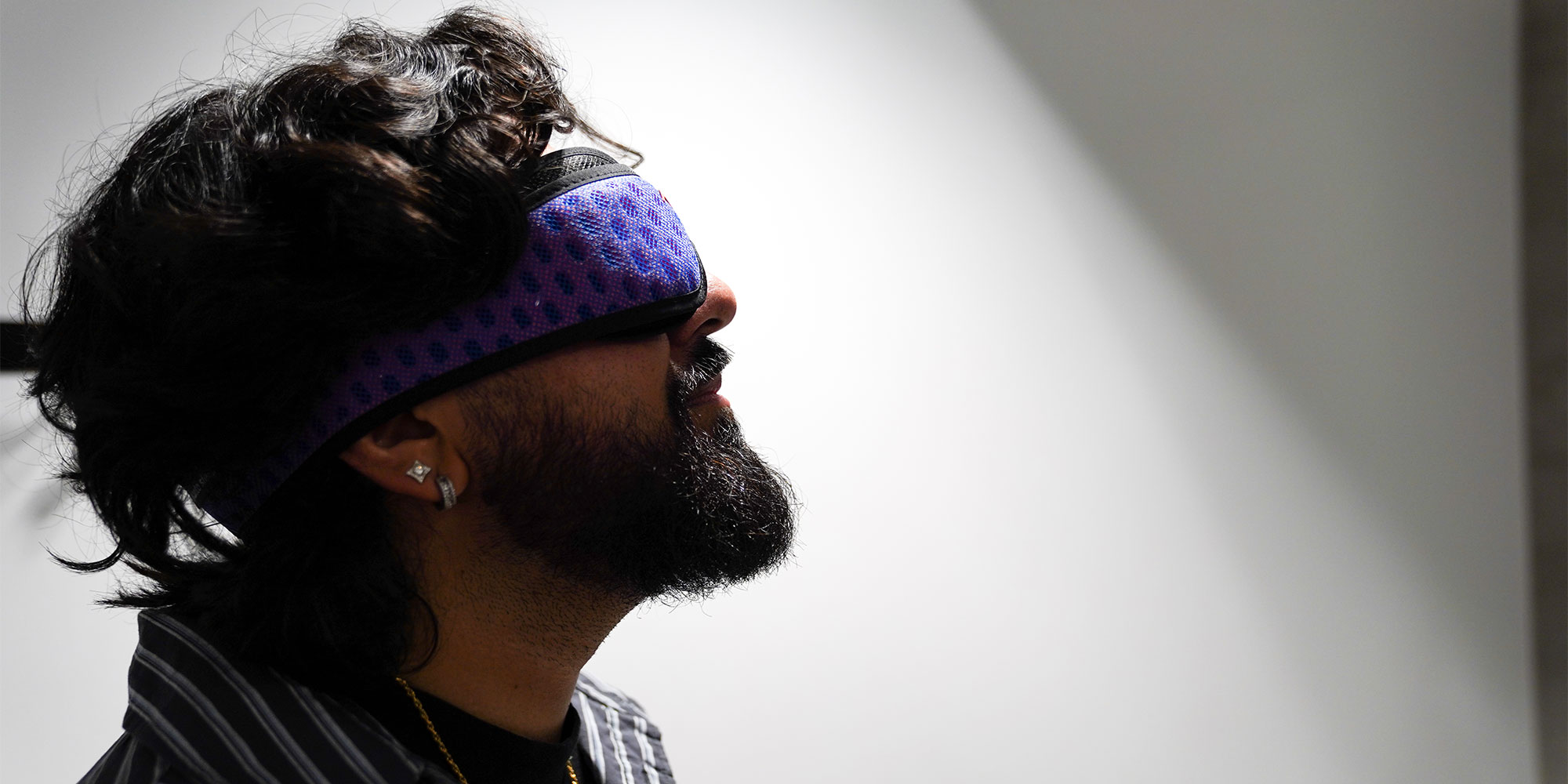 Someone wearing a purple sleep mask 