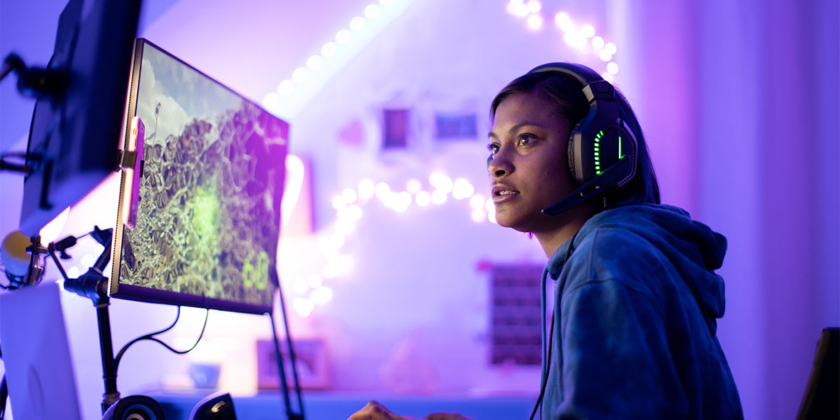 Girl playing video games with headphones on