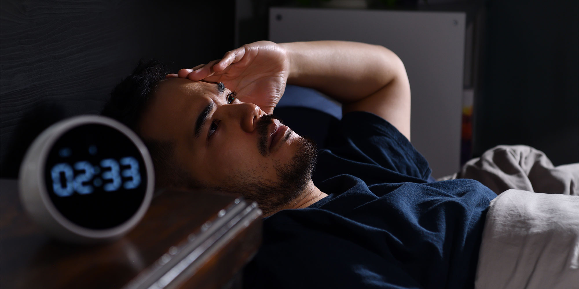 Man struggling to sleep