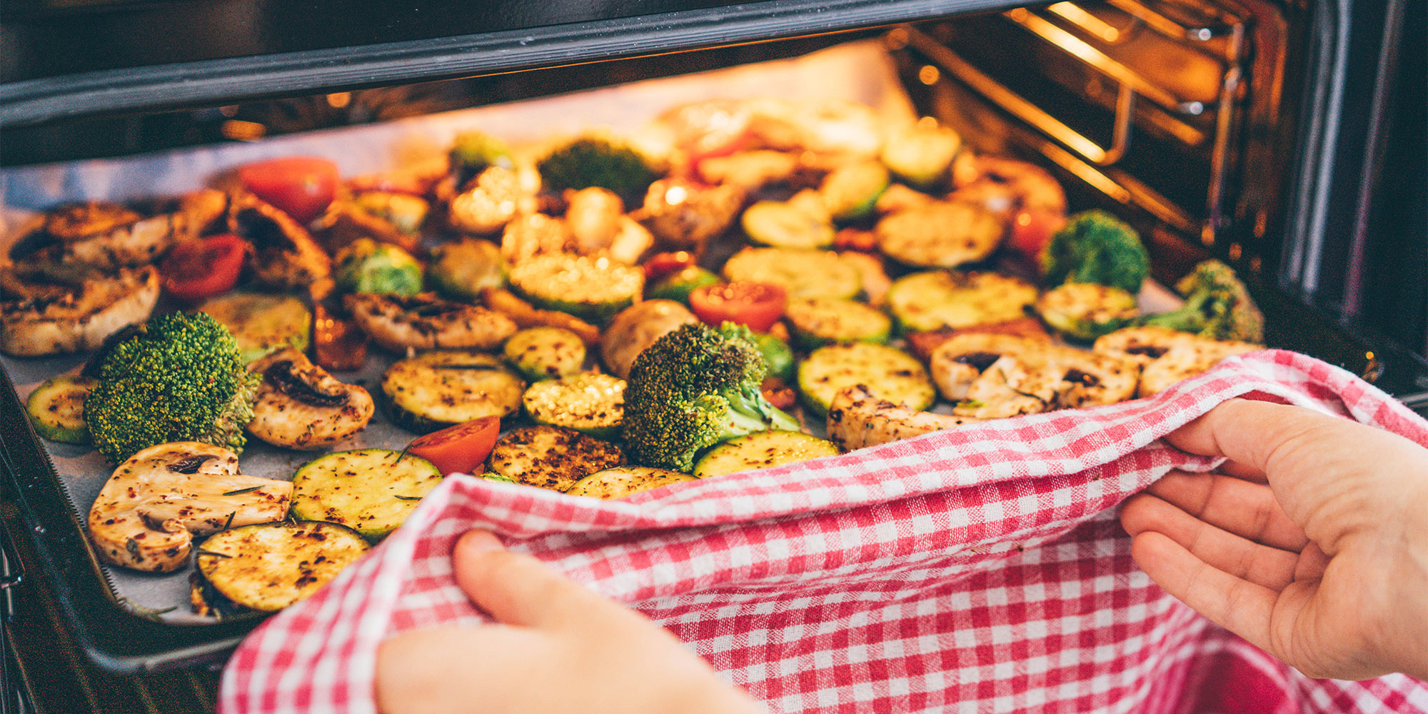 Tray of roasted vegetables on an oven tray inside an oven